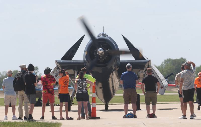 Spectators gather next to a TBM before it taks off during the 10th annual TBM Avenger Reunion and Airshow on Friday, May 16, 2025 at the Illinois Valley Regional Airport in Peru.
