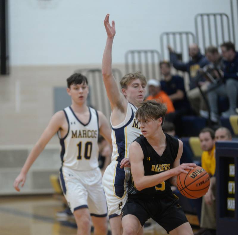 Ashton-Franklin Center's Aaron Lester looks to pass as he is guarded by Polo's Gage Zeigler on Tuesday, Jan. 2, 2024 at Polo High School.