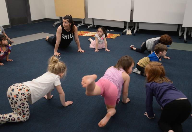 Leah Vaughan of La Grange Park and children ages pre K -2nd participate in Earth Day Yoga at La Grange Park Library Sunday April 13, 2025. The event was held to celebrate Earth Day and included them pretending to be various animals as well as various earth related elements.