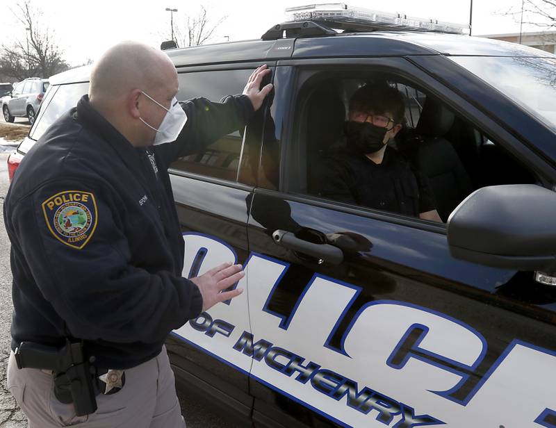 McHenry Police Department Public Affairs Officer Michael Spohn talks with Drake Rueckemann, 18, as Rueckemann prepares to start a ride-along with the McHenry Police Department on Monday, Feb 14, 2022. Rueckemann, who is a senior at McHenry High School, is taking part in an internship program as part of the school’s new social science class.