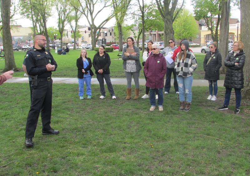 Ottawa Police Capt. Kyle Booras speaks to about 50 people in attendance Saturday, April 29, 2023, at Washinton Square in Ottawa, for the March to Believe organized by Safe Journeys.