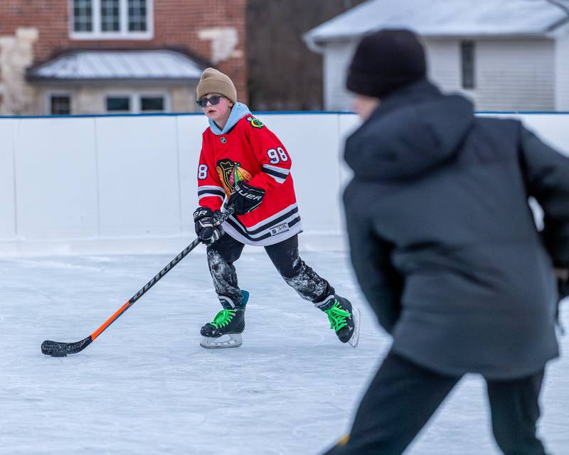 Weston Harris dribbles puck whilst iceskating at Schweickert Arena's Ice Rink on Tuesday, December 30, 2025, at Washington Park in Peru.