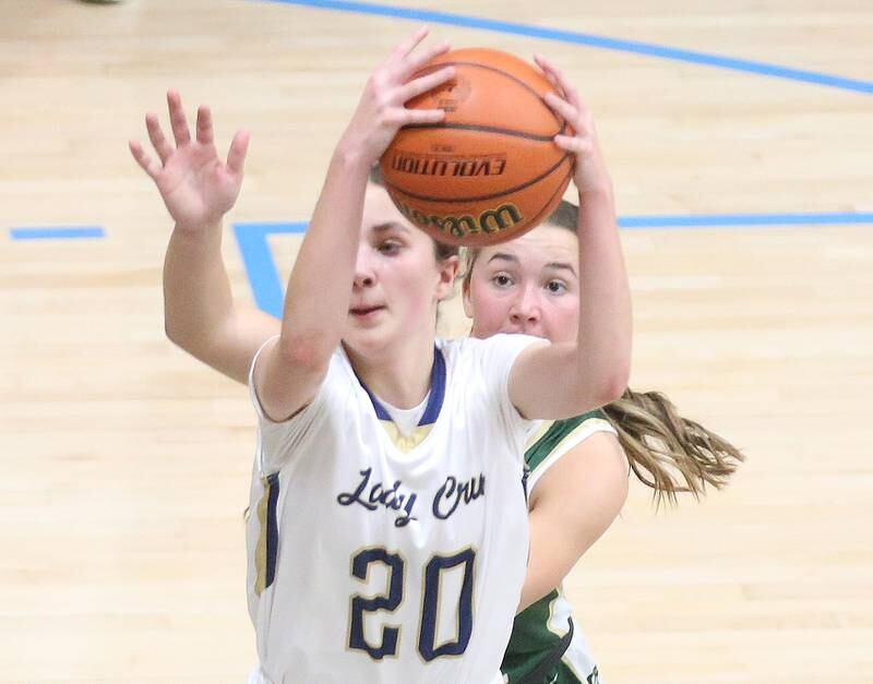 Marquette's Kaitlyn Davis grabs a rebound over St. Bede's Ella Hermes on Monday, Nov. 27, 2023 in Bader Gym at Marquette High School.