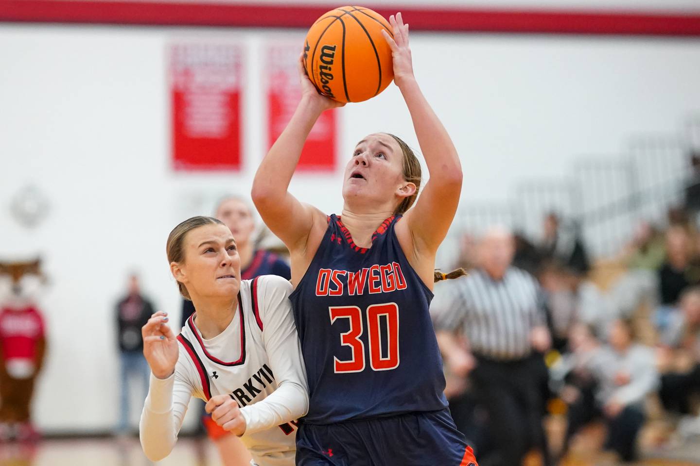 Oswego’s Peyton Johnson (30) shoots the ball in the post against Yorkville's Bella Phillips (10) during a hoops for hope basketball game at Yorkville High School on Saturday, Feb. 8, 2025.