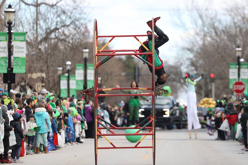 An entertainer performs tricks while rolling along the Plainfield Hometown Irish Parade on Sunday, March 17, 2024 in Plainfield.