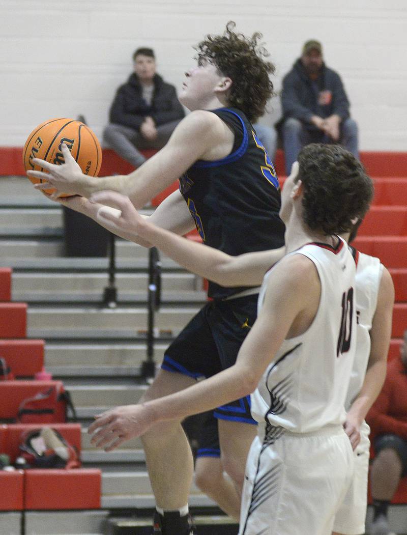 Somonauk’s Landon Johnson goes up and over Woodland’s Jaron Follmer to score in the 2nd period Wednesday at Woodland.
