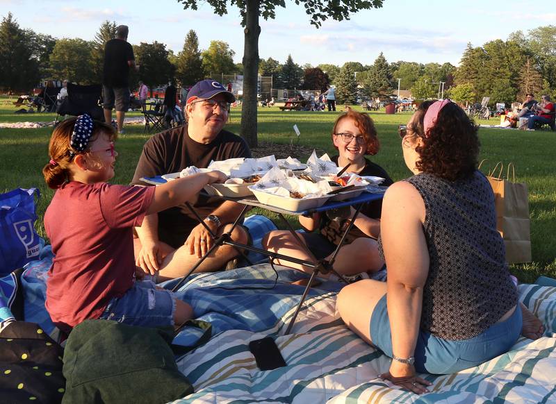 The Barnum/Whitfield family eats before the Elburn Fireworks Show at Lions Park on Saturday, July 6, 2024 in Elburn.