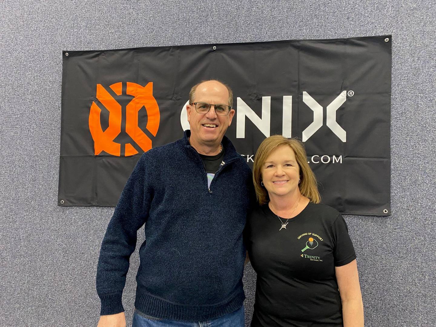 Thane Dykstra, chief executive officer and president of Trinity Services, is pictured with Annette Krapil, founding chair of Serving Up Support, the committee that planned and executed the pickleball fundraiser. The event raised $10,000 for Trinity Services and a new research-based virtual reality training system to help people with disabilities.