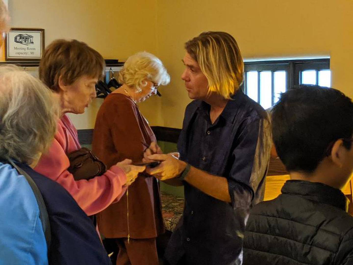 Mannheim Steamroller drummer Tom Sharpe greets fans after his Oct. 13, 2019, concert at the St. Charles Public Library.