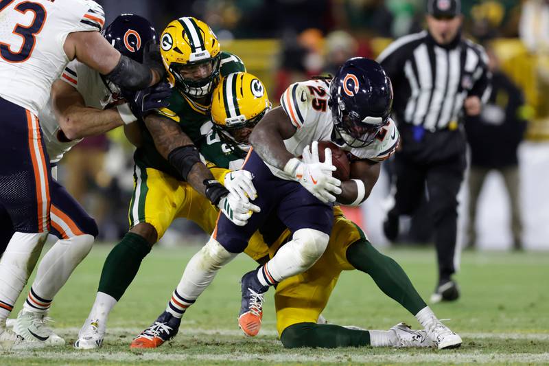 Green Bay Packers defensive end Micah Parsons (1) and safety Xavier McKinney (29) tackle Chicago Bears running back Kyle Monangai (25) during the second half of an NFL football game, Sunday, Dec. 7, 2025, in Green Bay, Wis. (AP Photo/Matt Ludtke)