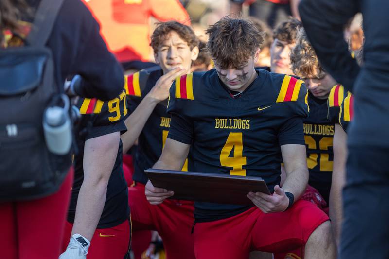 Batavia's Bodi Anderson looks at the plaque after the Class 7A Quarter Final on Saturday, Nov.15,2025 in Batavia.