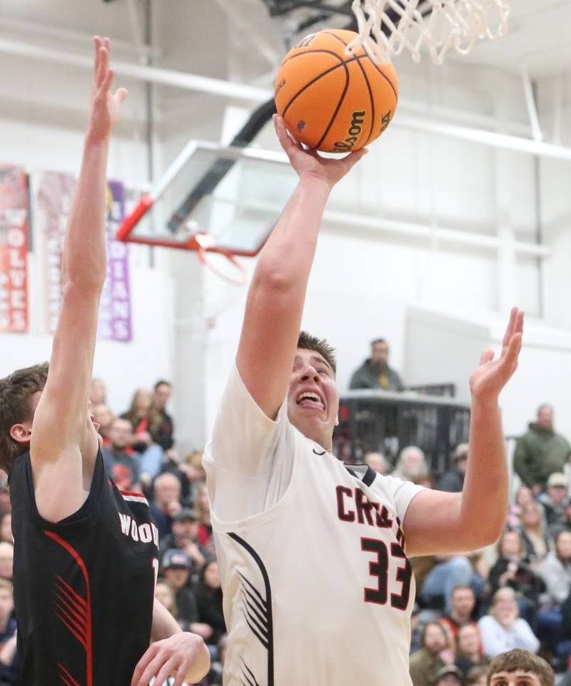 Indian Creek's Payton Hueber eyes the hoop as Woodland's Brezdyn Simons defends during the Class 1A Sectional Semifinal game on Wednesday, March 4, 2026 at Amboy High School.