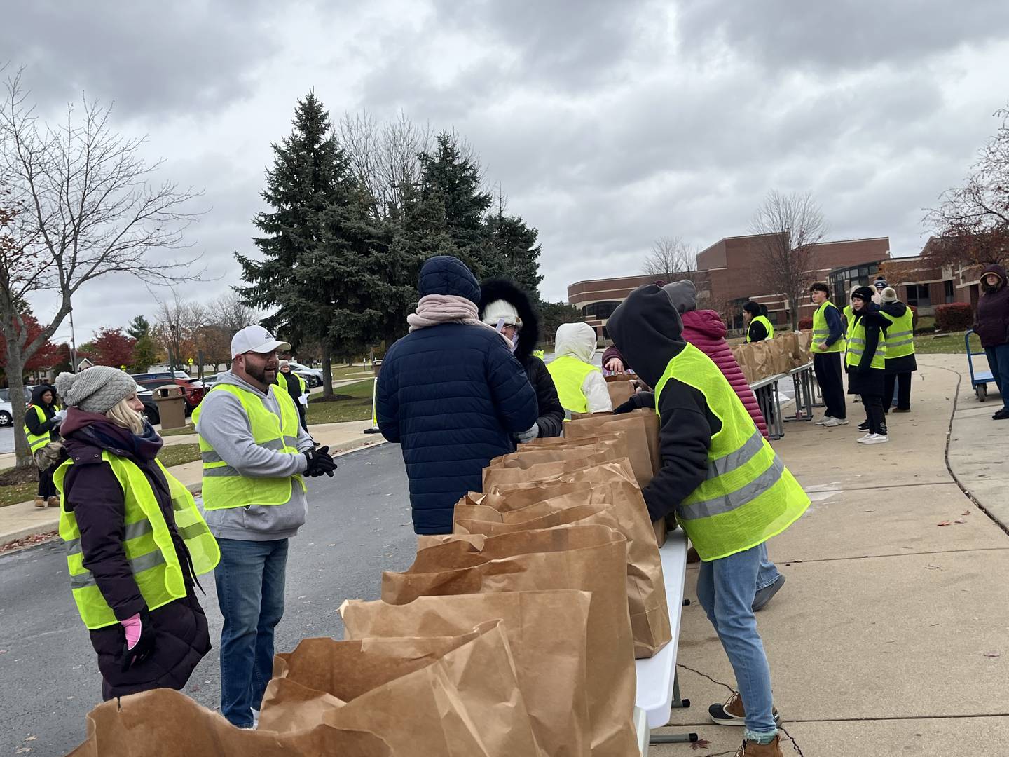 Volunteers organize bags of food during a community food drive outside the east campus for Lockport Township High School District 205 on Sunday, Nov. 9, 2025.