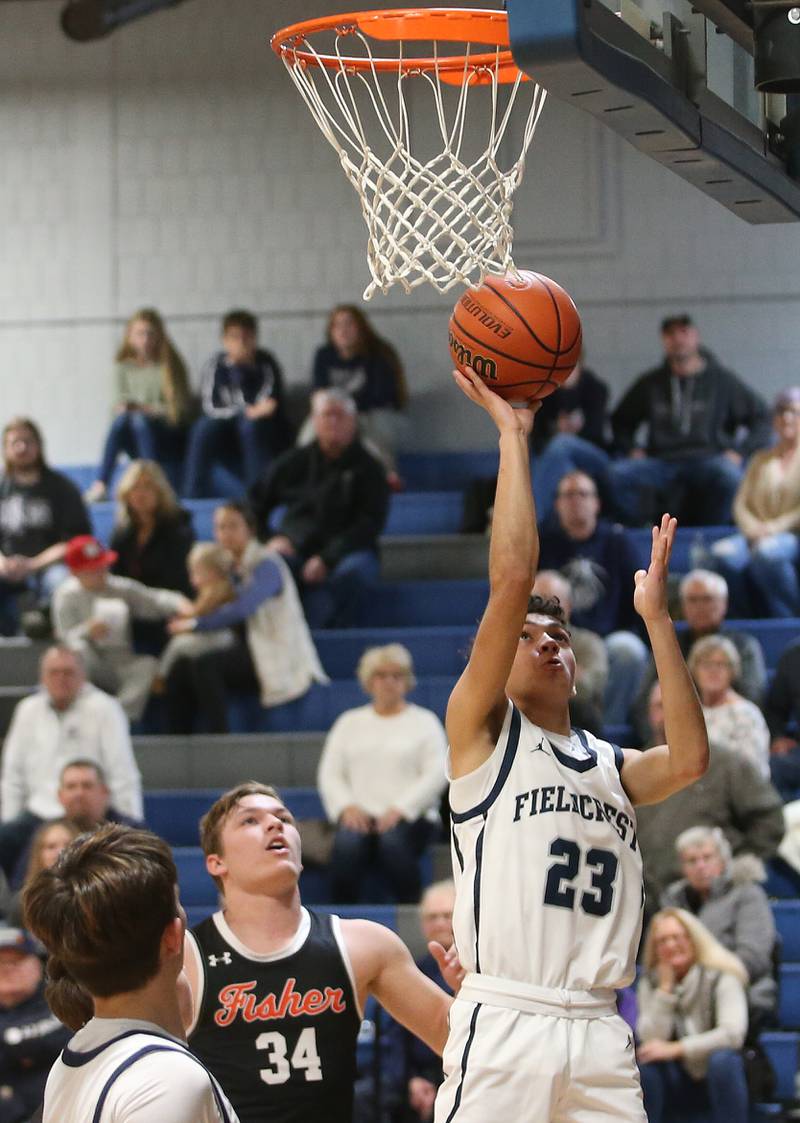 Fieldcrest's Jozia Johnson eyes the hoop after getting around Fisher's Jeremiah Todd on Tuesday, Jan. 2, 2024 at Fieldcrest High School.