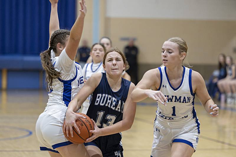 Bureau Valley’s Libby Endress splits Newman’s Lucy Oetting (left) and Jess Johns Thursday, Nov. 30, 2023 in Sterling.