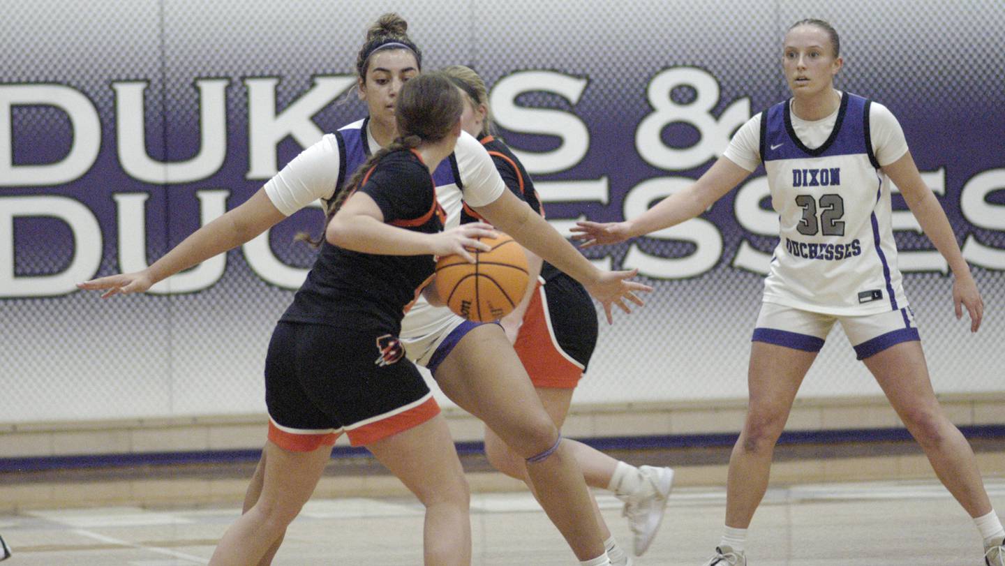 Byron's Brynn Green is defeneded by Dixon's Hallie Williamson and Makenzie Toms. The Dixon Duchesses hosted Byron in girls basketball Saturday, Jan. 25, 2025.
