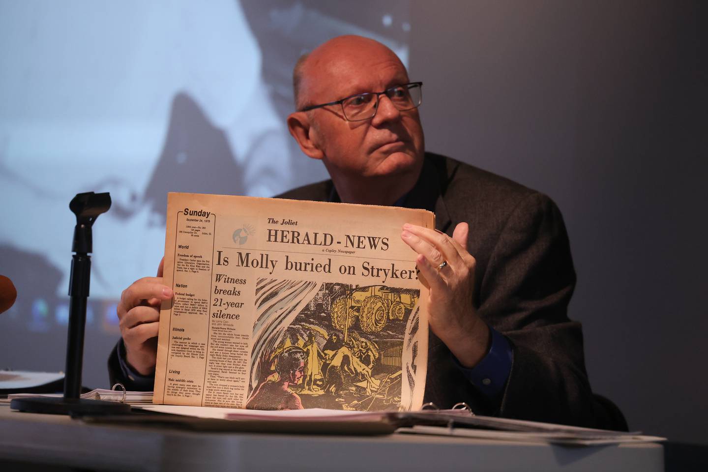 Lonny Cain, a writer and former city hall reporter for the Herald-News, holds up the paper John Whiteside and himself wrote that shed new light on a 21 year old case of a missing reporter “Molly” Zelko at the Joliet Area Historical Museum’s Unsolved History: Molly Zelko at 65 event. Saturday, Sept. 24, 2022, in Joliet.