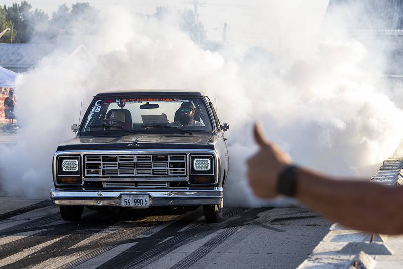A driver gets a thumbs up from a fan Thursday, June 19, 2025, as he hammers down the gas pedal for the burnout show in Rock Falls.