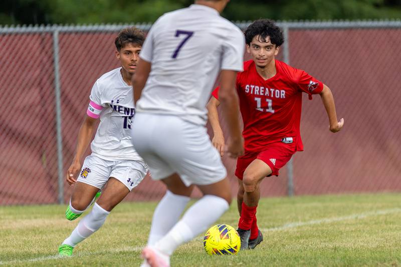 (from left) Sebastian Carlos (13) and Isaac Diaz (7) of Mendota surround Adrian Granados (11) of Streator as he dribbles ball upfield on Saturday, Aug 30, 2025 at the James Street Recreation Area in Streator.