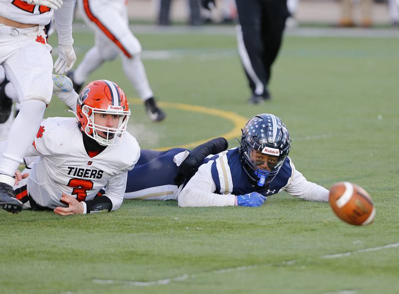 Byron's Braden Smith (3) and IC Catholic's KJ Parker (14) watch as a fumble rolls free during the Class 3A varsity football semi-final playoff game between Byron High School and IC Catholic Prep on Saturday, Nov. 19, 2022 in Elmhurst, IL.