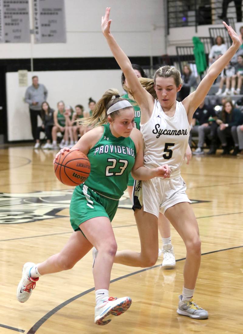 Providence Catholic's Annalise Pietrzyk tries to get through the defense of Sycamore's Faith Feuerbach during their game Tuesday, Feb. 22, 2022, in the Class 3A Kaneland sectional in Maple Park.