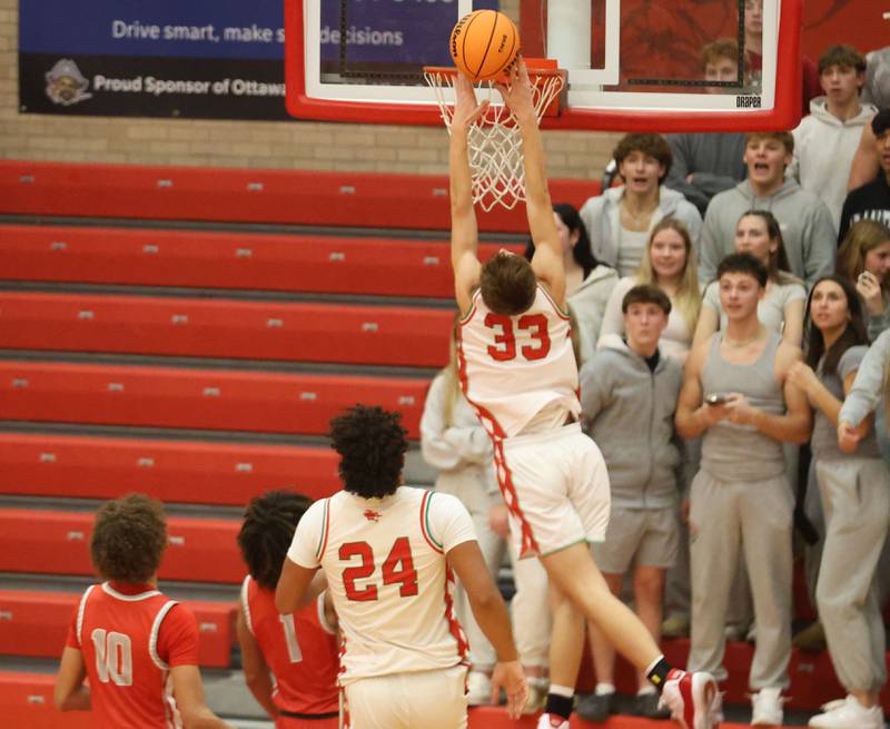 L-P's Gavin Stokes places the ball on the rim while running in for a layup during the Dean Riley Shootin' The Rock Thanksgiving Tournament on Monday Nov. 24, 2025 in Kingman Gymnasium at Ottawa High School.