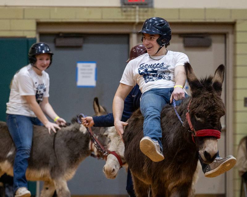Joey Arnold rides donkey down court during game of Donkey Basketball on Saturday, Feb. 7, 2026 at Seneca High School West Campus in Seneca.