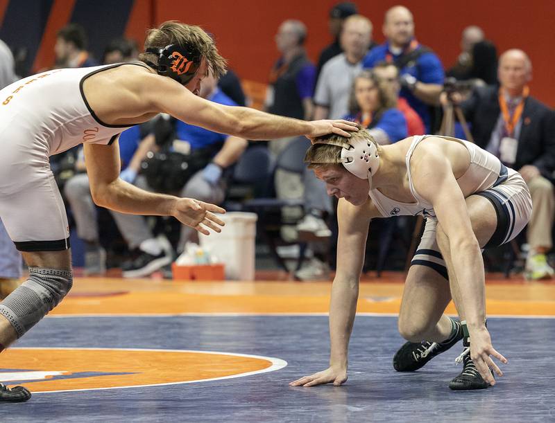 IC Catholic’s Aiden Arnett (right) and Washington’s Peyton Cox compete in the 144 pound weight class of the 2A state individual wrestling finals Saturday, Feb. 22, 2025, at State Farm Center in Champaign.