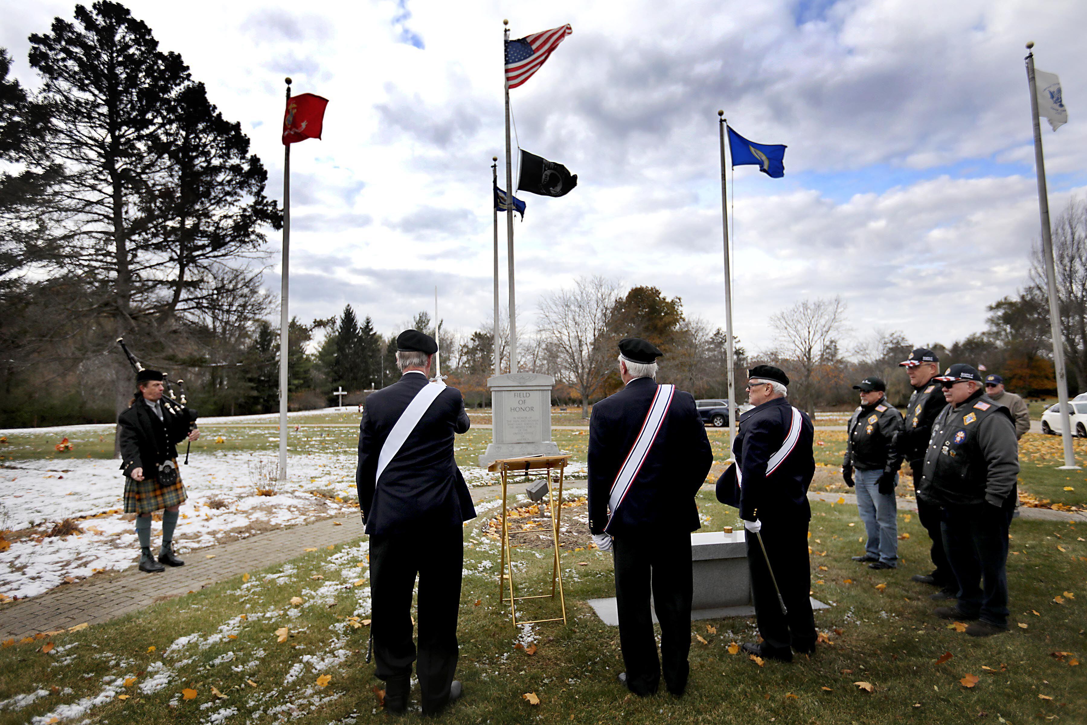 Members of the Knights of Columbus and supporters participate in a Veterans Day flag placement ceremony Tuesday, Nov. 11, 2025, at the gravesites of veterans at McHenry County Memorial Park Cemetery in Woodstock. Members of the Knights of Columbus Patriotic 4th Degree from the Bishop Boylan Assembly placed American Flags at nearly 140 veterans' grave markers.