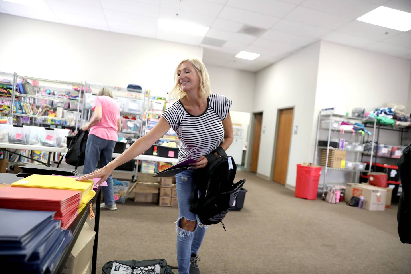 Big Hearts of Fox Valley volunteer Colleen Bittner of St. Charles fills backpacks with school supplies for students in St. Charles School District 303 as part of the organization’s back-to-school program in St. Charles.