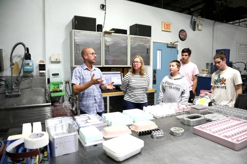 Mike Polansky (left), tooling designer at Tek Pak, Inc. in Batavia, talks with students from St. Charles School District 303’s Compass Academy on Wednesday, Oct. 23, 2024 as part of Manufacturing Month.