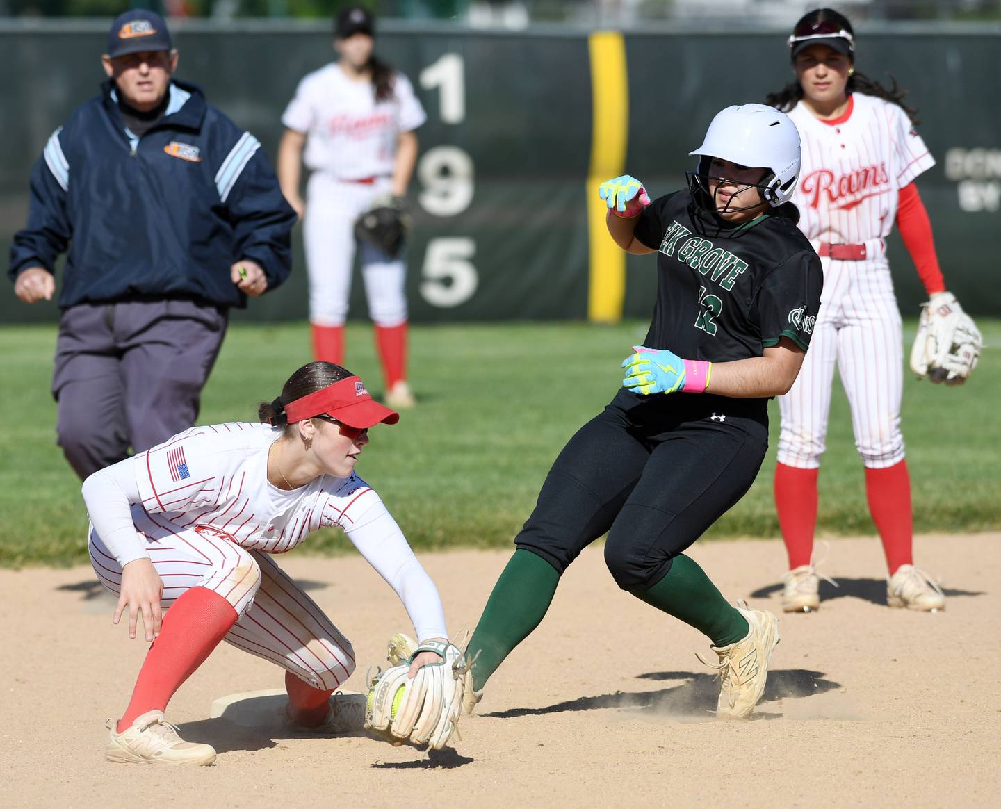 Elk Grove’s Bella Aguirre advances to second base as Glenbard East shortstop Lilly Carver takes the late throw during the Elk Grove regional semifinal softball game on Wednesday, May 20, 2026 in Elk Grove Village.