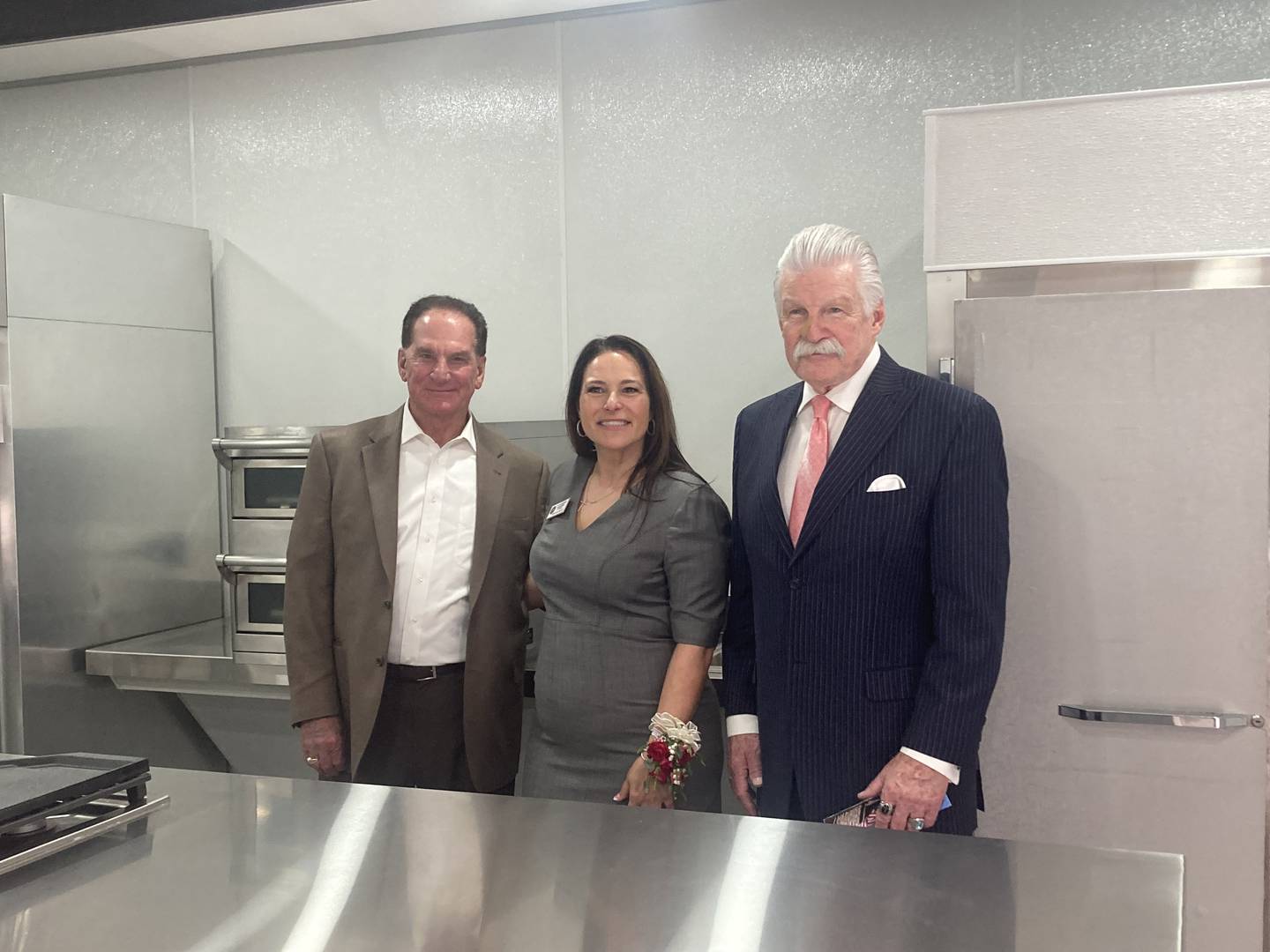 Will County ROE Superintendent Dr. Lisa Caparelli-Ruff stands in the new Lincoln School kitchen with John Bays and State's Attorney James Glasgow.