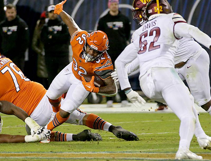 Chicago Bears running back David Montgomery (32) lunges for extra yards against the Washington Commanders on Thursday, Oct. 13, 2022 at Soldier Field.