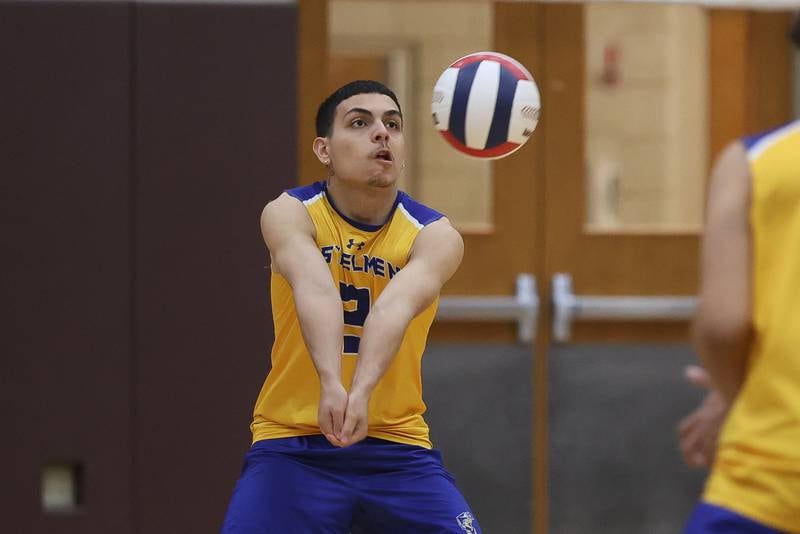 Joliet Central’s Ian Guzman makes a dig against Joliet Catholic on Wednesday, April 1, 2026 in Joliet.