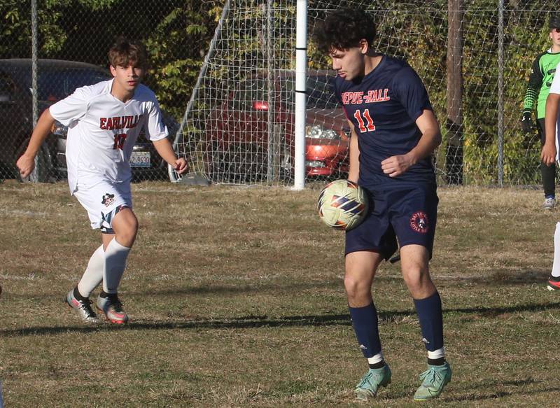 DePue/Hall's Grabiel Cano knocks the ball down in front of Earlville's Adin Hensley during the Class 1A Regional quarterfinal game on Wednesday, Oct. 16, 2024 in DePue.
