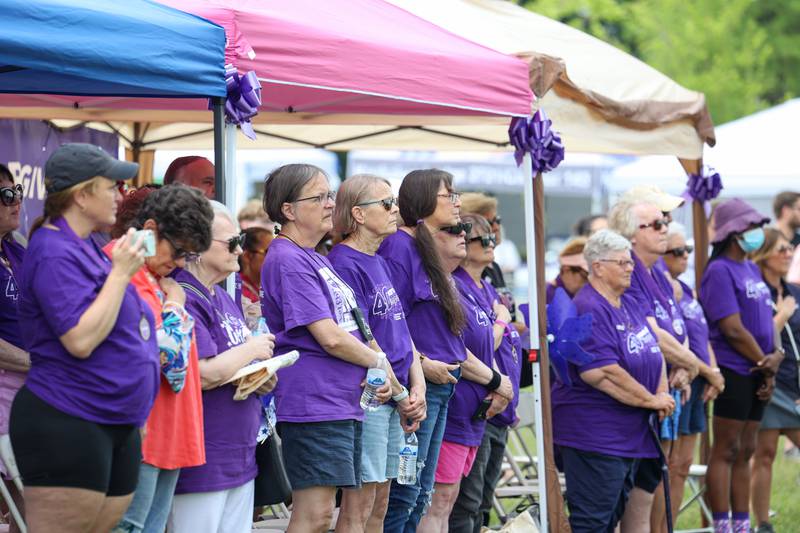 Cancer survivors and caregivers observe the national anthem during the opening ceremony for the Relay for Life of Kankakee County on June 14, 2025, at The Grove in Bourbonnais.