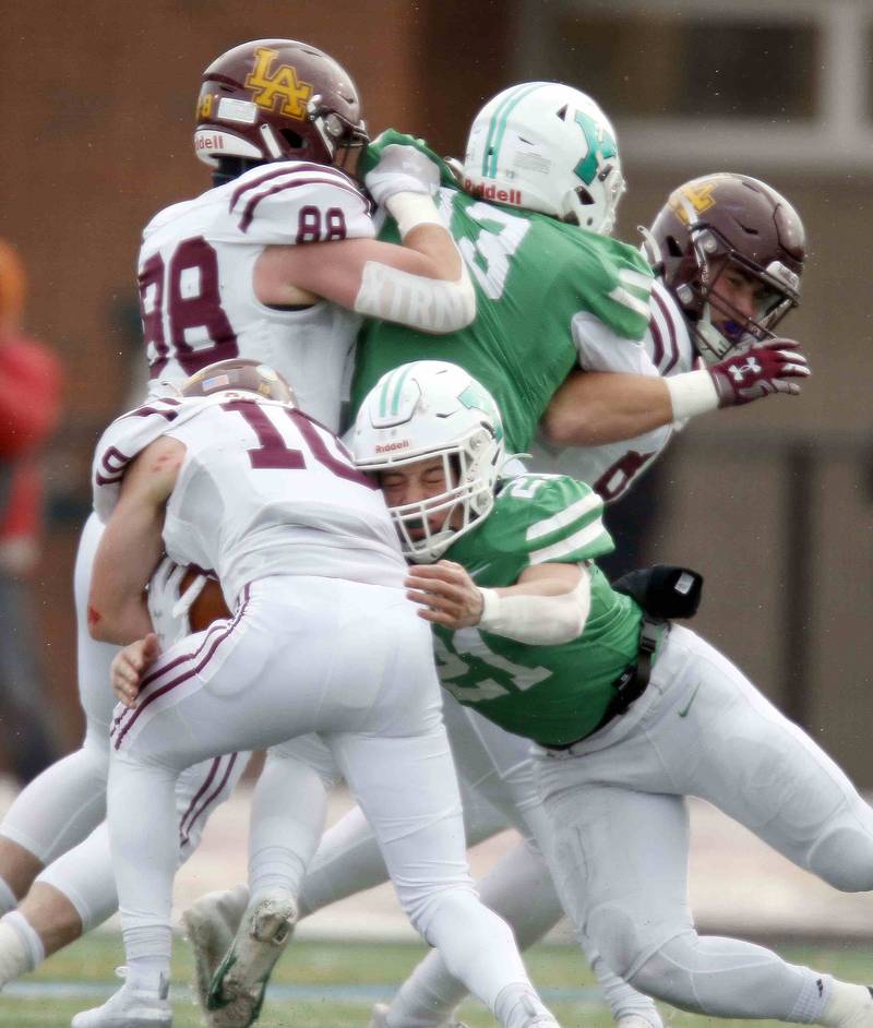 York’s Cole Ostendorf (21) tackles Loyola's Danny Herbert (10) during the IHSA Class 8A semifinal football game Saturday November 19, 2022 in Elmhurst.