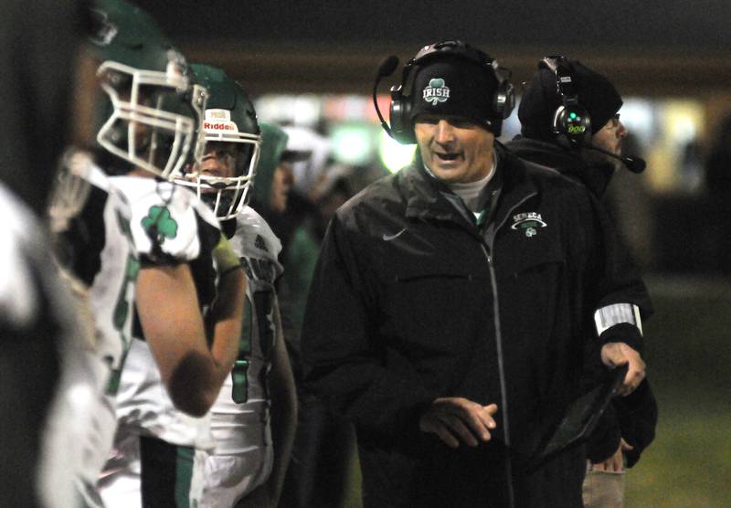 Seneca Fighting Irish head coach Terry Maxwell talks to his sideline at Gould Stadium on Friday, Oct. 6, 2023.