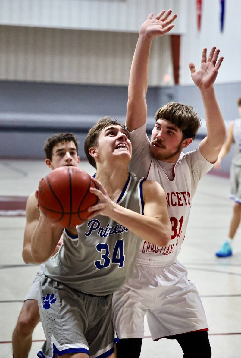 Princeton's Sheperd Bayer posts up against PCA's Jed Johns in Thursday's JV game at Howard Hoffman Memorial Gymnasium.