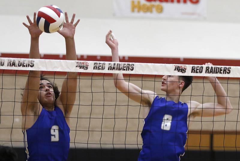 St. Charles North's Jesse Moreno blocks the ball as his teammate, Nathan Simpson, watches during a nonconference boys volleyball match against Huntley Monday, May 8, 2023, at Huntley High School.