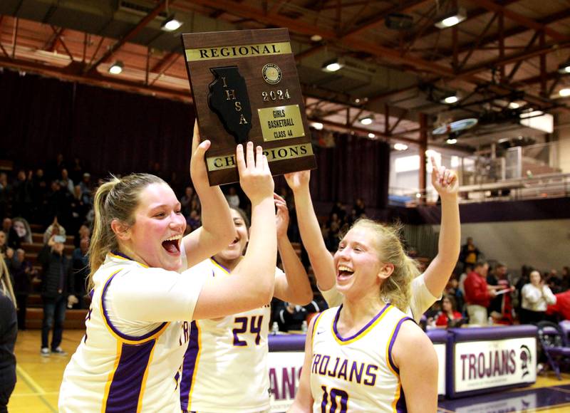 Downers Grove North’s Lilly Boor (left), Kaitlyn Parker (center) and Hope Sebek celebrate their Class 4A Downers Grove North Regional final win over Yorkville on Thursday, Feb. 15, 2024.