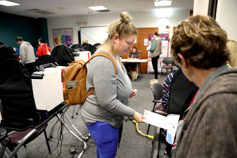 Rachel Rykse of Elburn casts her ballot with the help of election judge Ruth Walker at the Town and Country Library on Tuesday, Nov. 5, 2024 in Elburn.