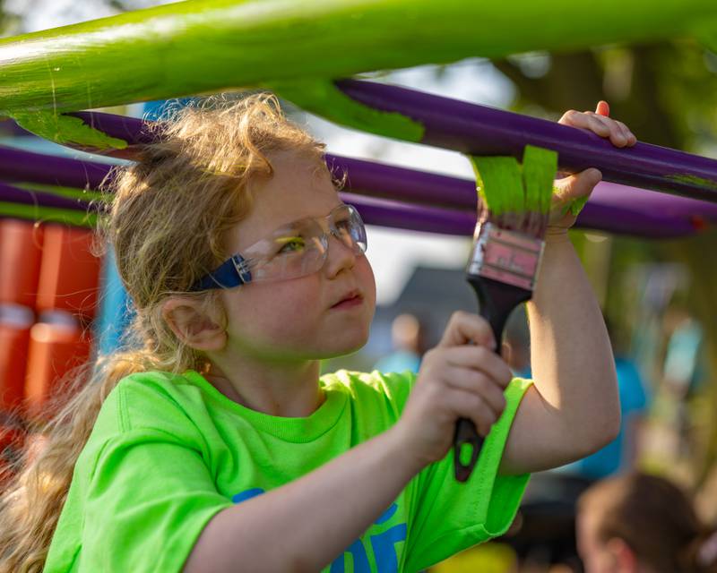 Skylar Hagemann paints the monkey bars at Ray Barto Memorial Park on June 3, 2025 in Seatonville.