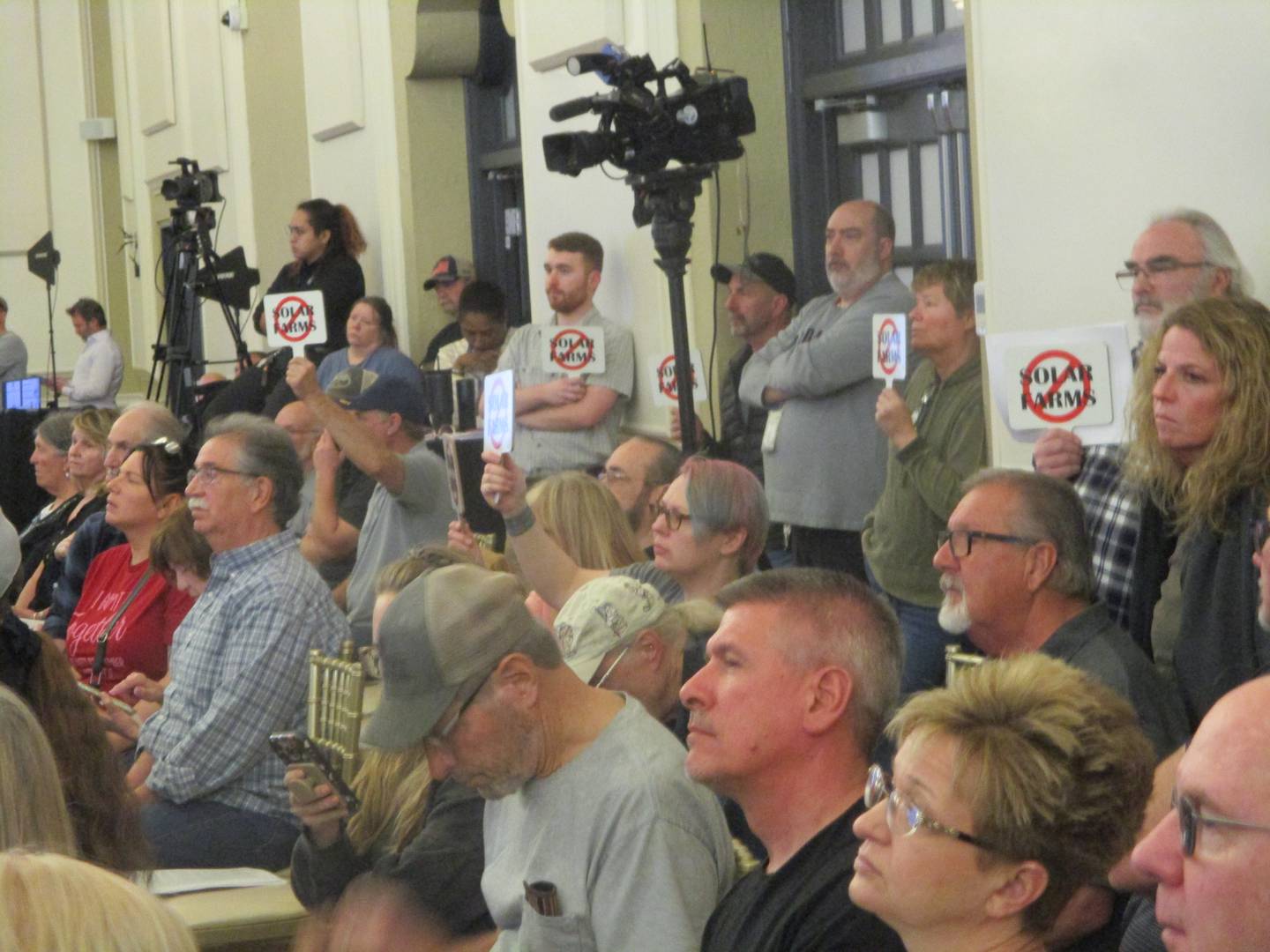 Many of the people who attended a public hearing on Monday held signs to show their opposition to Earthrise Energy's proposal for a 6,100-acre solar project. March 30, 2026