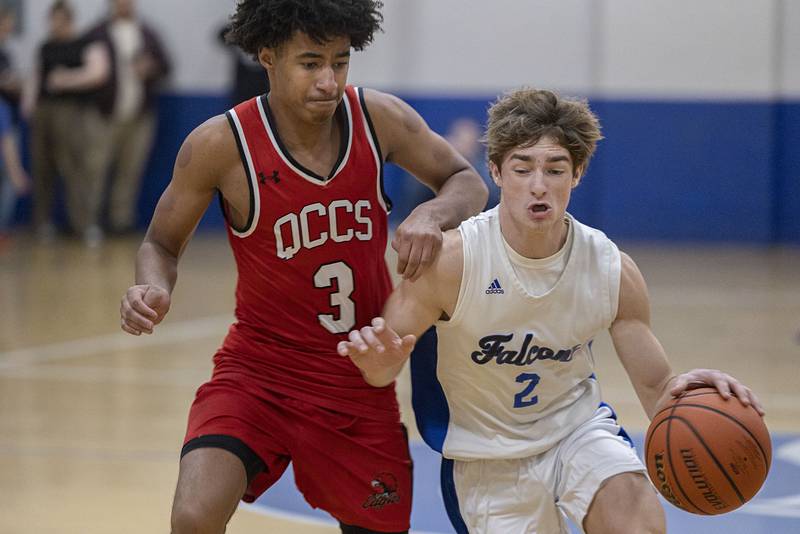 Faith Christian’s Carson Bivins drives against QC Christian’s Alijah Zentic Tuesday, Dec. 9, 2025.
