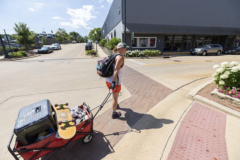 Reuter hauls her gear from post to post to let the base coat dry Monday, June 24, 2024.