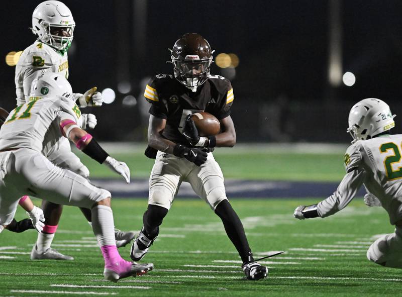 Joliet Catholic's Craig Peacock (5) runs the ball during the conference game against Providence Catholic on Friday, OCT. 24, 2025, at Joliet.
