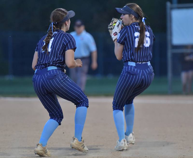 Downers Grove South third baseman Emily Hines (right) catches a soft popup as shortstop Addison Yurchak
Backs her up during a game against Downers Grove North on May 14, 2026 at McCollum Park in Downers Grove.