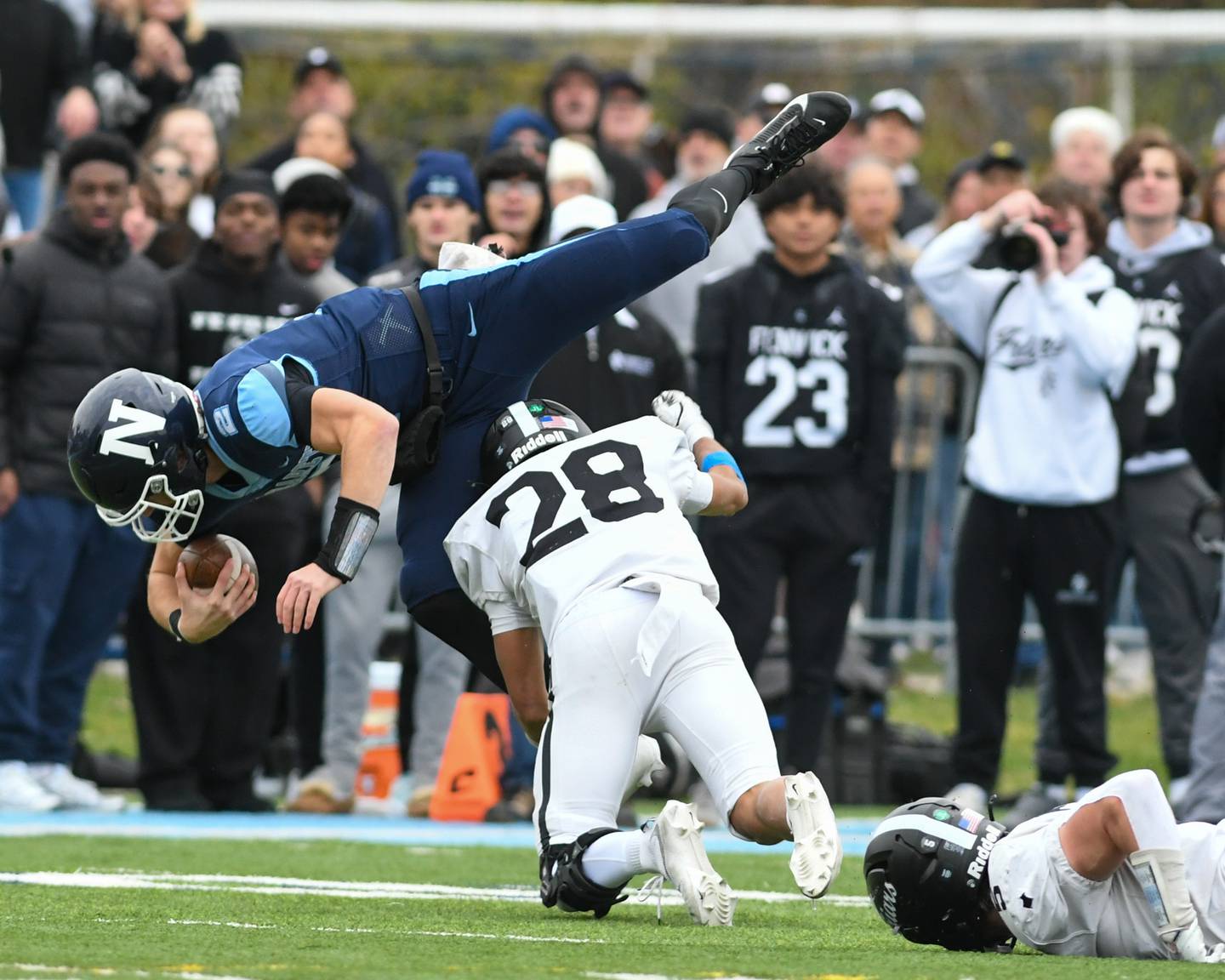 Nazareth Academy's Jackson Failla (2) gains some yards before being tripped up by Fenwick's Aiden Williams (28) during the 6A semifinals game on Saturday Nov. 22, 2025, held at Nazareth Academy High School in La Grange Park.